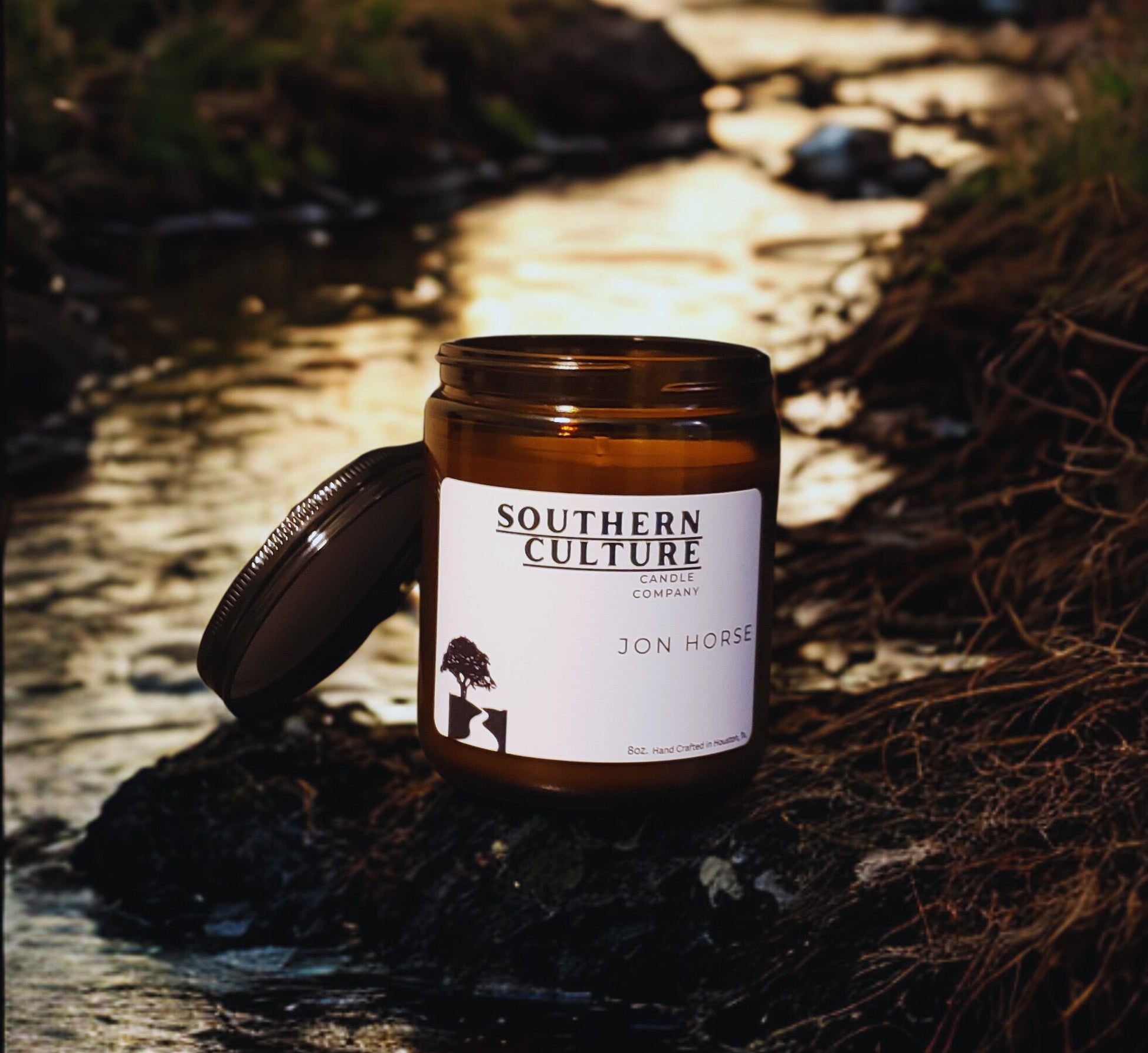 Candle jar with 'Southern Culture Candle Company' label on a natural background
