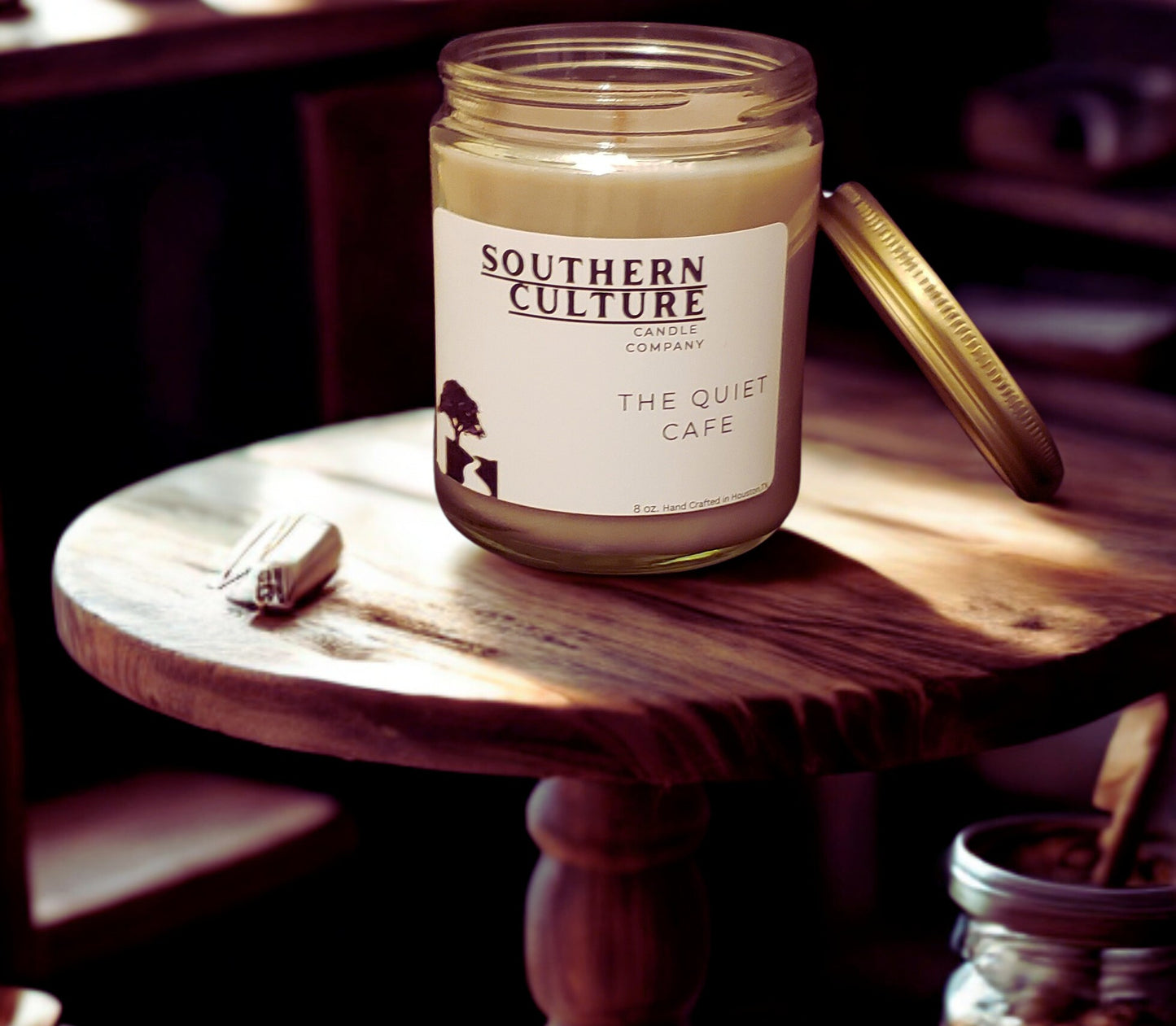 Jar of 'The Quiet Cafe' candle from Southern Culture Candle Company on a wooden surface.